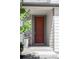 Close-up of a classic red front door with stone and siding accents on a well maintained house at 6117 Easton Cir, Frederick, CO 80504