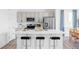 Modern kitchen with stainless steel appliances, quartz countertops, and sleek black barstools at 6117 Easton Cir, Frederick, CO 80504