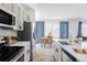 Bright and modern kitchen featuring stainless steel appliances, white countertops, and sleek cabinetry at 6117 Easton Cir, Frederick, CO 80504