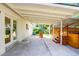 Covered patio with a built-in hot tub, ideal for outdoor relaxation at 3055 S Winona Ct, Denver, CO 80236
