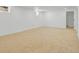 Spacious finished basement with neutral carpeting, freshly painted white walls, and ample room for customization and entertainment at 3055 S Winona Ct, Denver, CO 80236