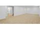 Expansive finished basement with neutral carpeting, stairs and access to bathroom, ready for a variety of uses at 3055 S Winona Ct, Denver, CO 80236