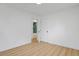 Bright room with open bathroom door, wood-look floors, and modern white doors creates a clean and inviting space at 3055 S Winona Ct, Denver, CO 80236