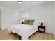 Bright bedroom features a comfortable bed with side tables and lamps at 3055 S Winona Ct, Denver, CO 80236