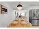 Open floor plan dining area adjacent to kitchen, stainless steel refrigerator at 3055 S Winona Ct, Denver, CO 80236