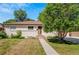 Charming single-story home featuring a well-maintained lawn and mature landscaping at 3055 S Winona Ct, Denver, CO 80236
