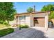 Angle of house with garage with stylish glass accents and new landscaping at 3055 S Winona Ct, Denver, CO 80236