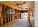 Unfinished garage showing framing with electrical panel and a door to the outside at 3055 S Winona Ct, Denver, CO 80236