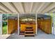 View of a hot tub with wooden steps and a metal carport like cover with privacy screens at 3055 S Winona Ct, Denver, CO 80236