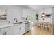 Bright modern kitchen with access to the dining area at 3055 S Winona Ct, Denver, CO 80236