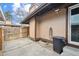 View of backyard patio featuring partial fence and hose on a sunny day at 3746 S Fairplay Way, Aurora, CO 80014
