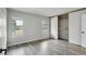 Bedroom featuring sliding closet doors, hardwood floors, and updated windows at 3746 S Fairplay Way, Aurora, CO 80014