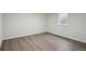 Finished basement bedroom with hardwood floors, white walls, and a basement window at 3746 S Fairplay Way, Aurora, CO 80014