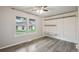 Bright bedroom with hardwood floors, a large window, and built-in closet shelving at 3746 S Fairplay Way, Aurora, CO 80014