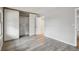 A simple bedroom with hardwood floors, neutral walls, and a sliding closet at 3746 S Fairplay Way, Aurora, CO 80014