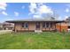 Charming home with a well-maintained lawn and a cozy front porch under a cloudy blue sky at 3746 S Fairplay Way, Aurora, CO 80014