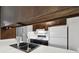 Close-up of the kitchen sink, counter, and cabinets, showcasing functionality at 3746 S Fairplay Way, Aurora, CO 80014