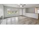 Bright living room with hardwood floors, fireplace, and ample natural light from large windows at 3746 S Fairplay Way, Aurora, CO 80014