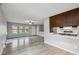 Open layout of the living room, features hardwood floors, and a view to the kitchen area at 3746 S Fairplay Way, Aurora, CO 80014