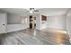 Open-concept living space with gray hardwood floors, combining kitchen and living area at 3746 S Fairplay Way, Aurora, CO 80014