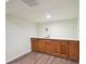 Finished basement wet bar area featuring hardwood floors, oak cabinets, and white countertops at 3746 S Fairplay Way, Aurora, CO 80014