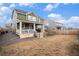 Spacious backyard with a wooden fence, a covered porch, and a grassy area ready for landscaping or activities at 16317 Saint Paul St, Thornton, CO 80602