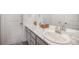 Bathroom featuring dual sinks with marble countertops and modern fixtures, creating a clean and functional space at 16317 Saint Paul St, Thornton, CO 80602