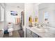 Bright bathroom with a vanity, decorative mirror, tiled shower, and coordinated towels and decor at 16317 Saint Paul St, Thornton, CO 80602