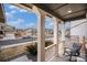 Inviting covered porch with sturdy columns, a rocking chair, and a view of the neighborhood street at 16317 Saint Paul St, Thornton, CO 80602