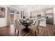 Bright kitchen dining area featuring pendant lighting, stainless steel appliances, and sliding glass doors to the backyard at 16317 Saint Paul St, Thornton, CO 80602