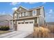 Charming two-story home featuring a large two-car garage, stone accents, and well-maintained landscaping at 16317 Saint Paul St, Thornton, CO 80602