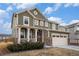 Charming two-story house with a front porch and two-car garage, complemented by a well-kept lawn at 16317 Saint Paul St, Thornton, CO 80602