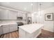 Well-equipped kitchen featuring a center island, stainless steel appliances, and stylish gray cabinetry at 16317 Saint Paul St, Thornton, CO 80602