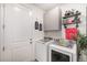 Functional laundry room with modern washer and dryer, shelving, and plenty of storage space at 16317 Saint Paul St, Thornton, CO 80602