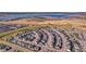 Aerial view of a neighborhood with view of the plains and a large lake in the distance at 11299 Star Streak Ln, Littleton, CO 80125