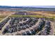 Aerial view of a neighborhood with a red marker showing a subject house and lake in the distance at 11299 Star Streak Ln, Littleton, CO 80125