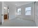 Bright bedroom with neutral carpet, with natural light and an ensuite bathroom with a wood vanity at 11299 Star Streak Ln, Littleton, CO 80125