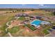 Aerial view of the community pool, playground and outdoor amenities in a well manicured and landscaped community at 11299 Star Streak Ln, Littleton, CO 80125
