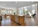 Gourmet kitchen boasts a large island with seating, stainless appliances, and is connected to a dining and living area at 11299 Star Streak Ln, Littleton, CO 80125
