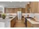 Modern kitchen with sleek stainless-steel appliances, custom cabinets, white countertops, and stylish backsplash at 11299 Star Streak Ln, Littleton, CO 80125