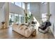 Spacious living room featuring hardwood floors, lots of natural light, modern furniture and a fireplace at 11299 Star Streak Ln, Littleton, CO 80125