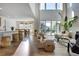 An open floor plan featuring high ceilings, and large windows allowing lots of natural light and an adjacent dining area at 11299 Star Streak Ln, Littleton, CO 80125