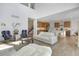 Open-concept space with high ceilings seamlessly connects the living room to a kitchen with wooden cabinets at 11299 Star Streak Ln, Littleton, CO 80125