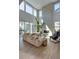 Bright living room features soaring ceilings, fireplace, neutral decor, and large windows offering lots of natural light at 11299 Star Streak Ln, Littleton, CO 80125