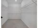 A walk-in closet with carpeted flooring and white shelving with rods on all three sides at 11299 Star Streak Ln, Littleton, CO 80125