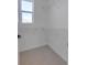 A walk-in closet with carpeted flooring, a window, and white shelving with rods at 11299 Star Streak Ln, Littleton, CO 80125
