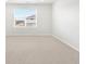 Bright bedroom with a large window and neutral carpeting at 754 N Tempe St, Aurora, CO 80018