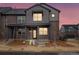 Charming two-story townhome with a brick facade and inviting front porch, set against a vibrant twilight sky at 754 N Tempe St, Aurora, CO 80018