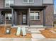 Inviting front porch with brick facade, modern door, and well-kept landscaping leading to the entrance at 754 N Tempe St, Aurora, CO 80018