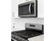 Modern kitchen featuring stainless steel microwave and stove at 754 N Tempe St, Aurora, CO 80018